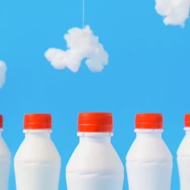 3 milk bottles on blue background